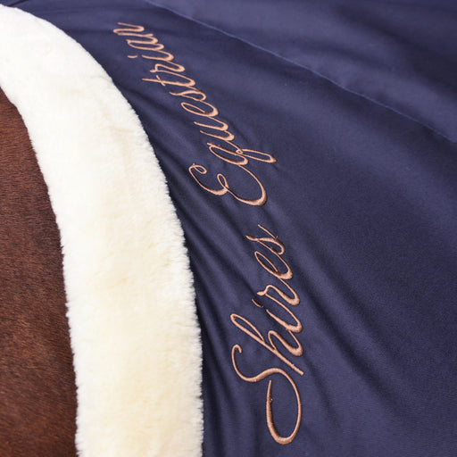 Shires Deluxe Stable Sheet (No Fill) in Navy - Closeup of Shires logo